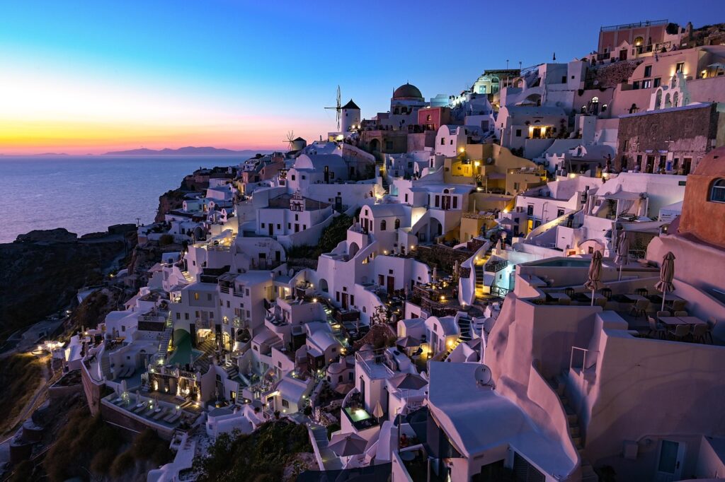 Sunset view of the ocean and villas at Santorini Greece 