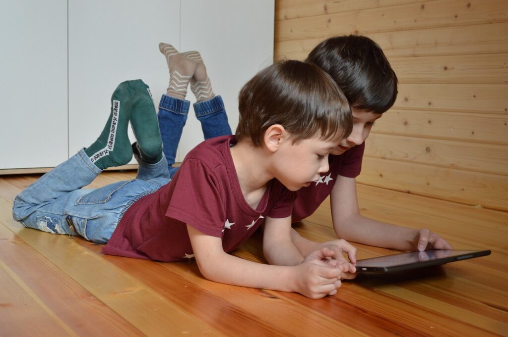 two brothers playing with a tablet