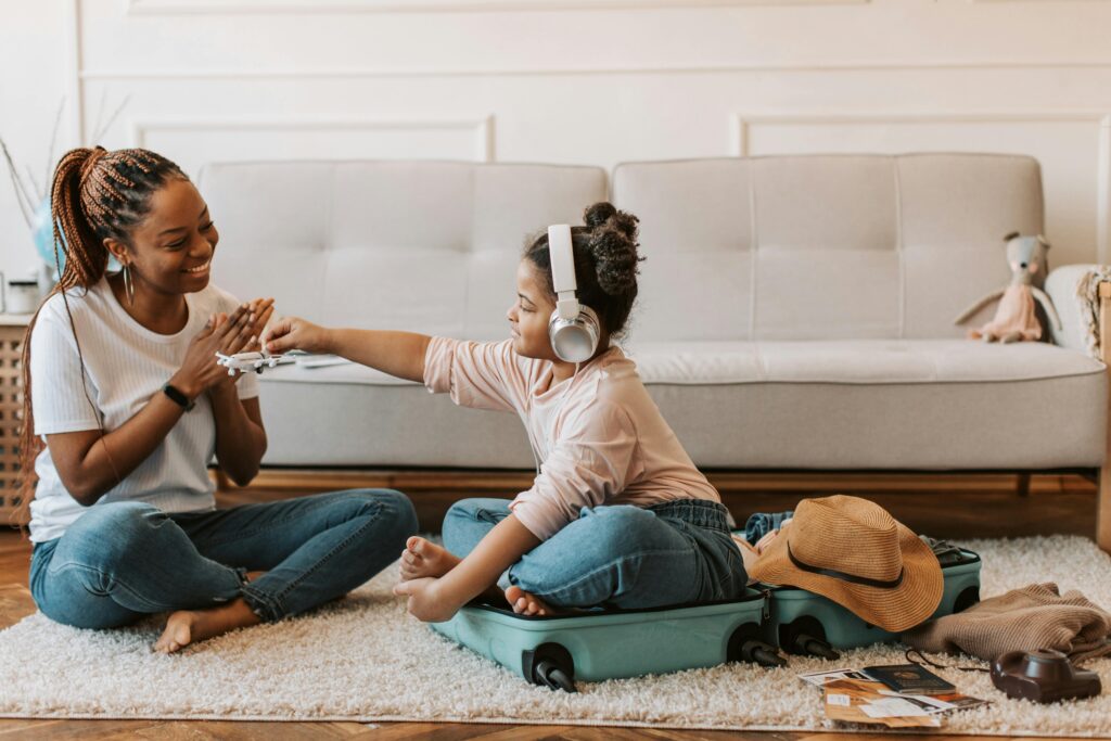 Mother and daughter packing for travel