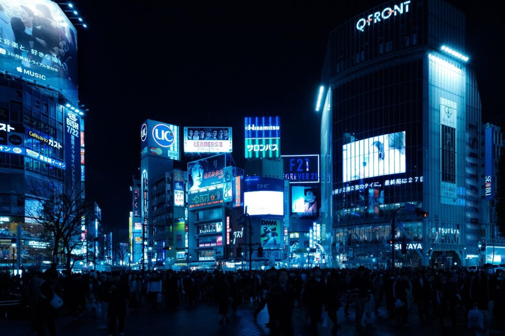 Shibuya Crossing Tokyo at night with neon lights and busy crowds